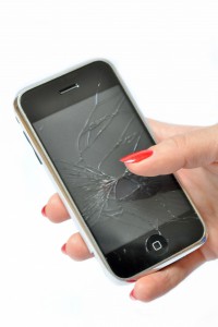 5249770-girl-with-red-nails-holding-a-mobile-phone-with-broken-screen
